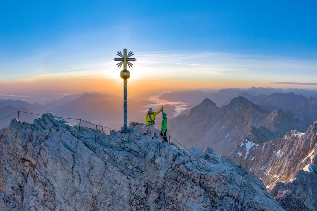 Gipfelerfolg auf der Zugspitze mit Blick über Jubiläumsgrat und Alpspitze in den Sonnenaufgang